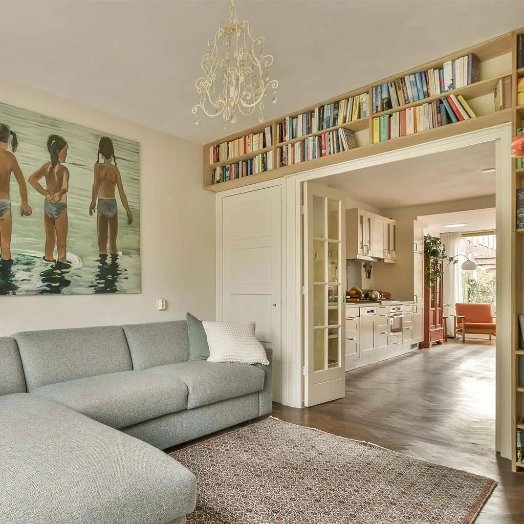 Calm living room with gray sofa and bookshelves